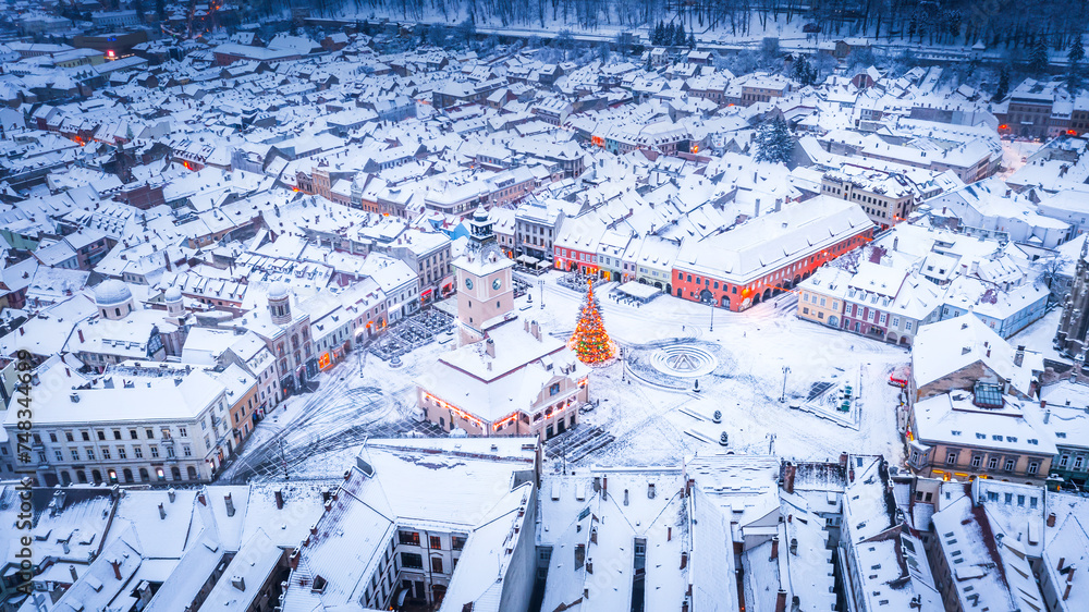 Brasov, Romania, Transylvania - Council Square and Christmas Tree, aerial winter view.