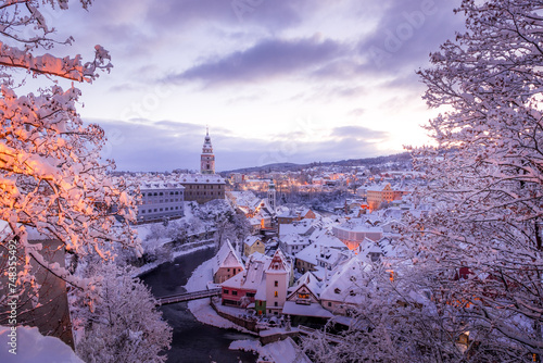 Winter view of Cesky Krumlov, picturesque houses under the castle with snow-covered roofs. Narrow streets and the Vltava river. Travel and Holiday in Europe. UNESCO World Heritage. Czechia
