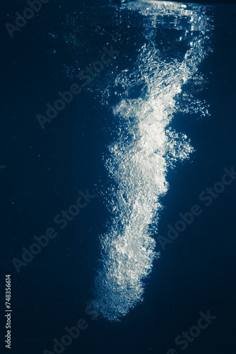 underwater splash bubbles in blue water environment © nikkytok