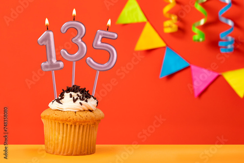Number 135 candle - Birthday cupcake on orange background with bunting