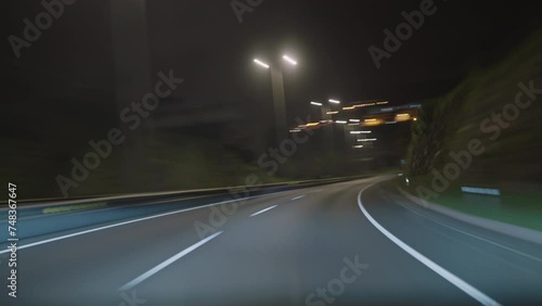 Timelapse of a speedy night drive trip through the Madeira tunnels. View from the car windshield to the road. Hyperlapse road trip sort of dashcam POV. Travel Concept Madeira island photo