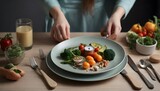 Realistic photo of a plate of wholesome food and a clock on a kitchen table, and female hands holding cutlery. The theme of interval fasting, weight loss and health.