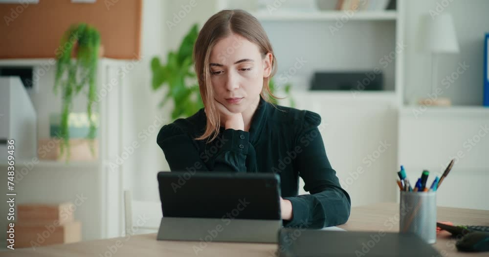 Worried young businesswoman using digital tablet Worried young businesswoman using digital tablet