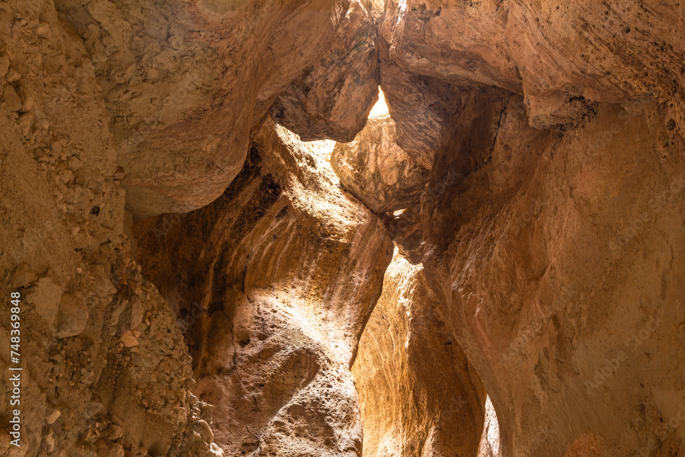 Obraz premium Karadakh gorge. Sunlight in a mountain Canyon. Beautiful curved crevice in sunny weather. Creation erosion of yellow sandstone by water acquired twisted shape natural Origin. Dagestan, Russia, Europe