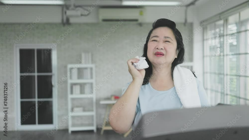 daughter gives her mother water to drink while exercising at home daughter gives her mother water to drink while exercising at home