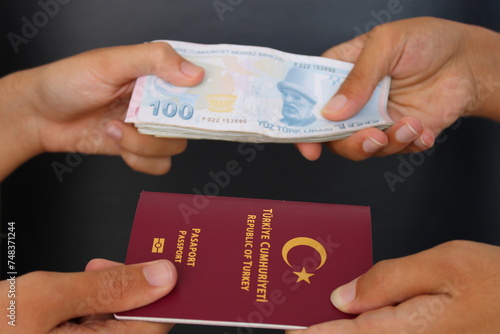 Fototapeta Naklejka Na Ścianę i Meble -  The hands of two men holding Turkish passports.. Buying a passport for money. fake passport.