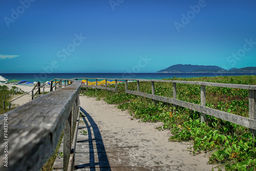 Path leading to the edge of a beautiful beach with mountains in the background  located in the city of Cabo Frio  Rio de Janeiro.
