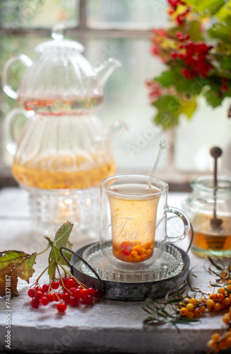 Still life with sea buckthorn. sea buckthorn tea. Autumn naturmort with sea buckthorn tea and honey. © Inna