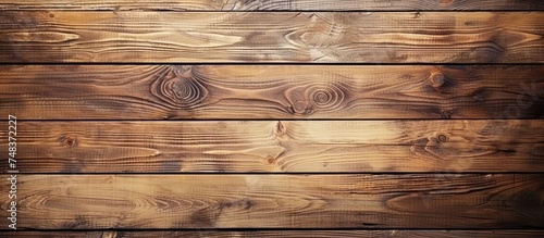 A detailed view of beautiful wooden wall boards arranged on a rustic wooden background, exuding a textured wood feel. The natural grains and knots enhance the rustic charm of the wall.