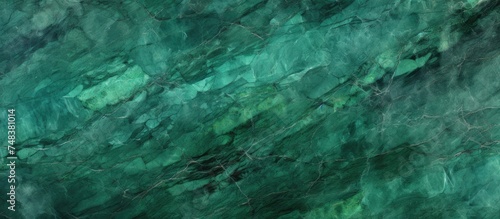 This is a close-up view of a green marble texture background, showcasing the intricate patterns and shades of green present in the natural stone. The surface appears smooth and glossy,