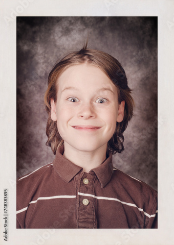 фотографія Bad school portrait of an awkward grinning boy