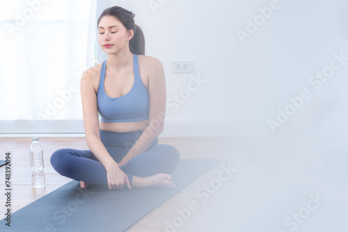 Two women confident training yoga. Athletic women in sportswear doing fitness stretching exercises at home in the living room. Sport and recreation concept. Yoga teacher is helping young woman.