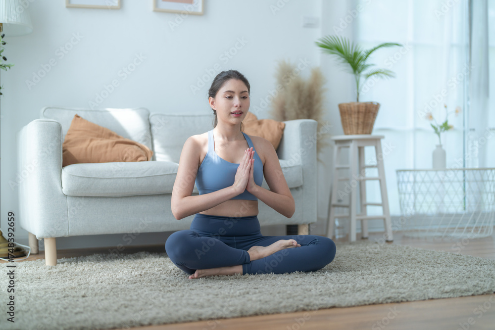 Two women confident training yoga. Athletic women in sportswear doing fitness stretching exercises at home in the living room. Sport and recreation concept. Yoga teacher is helping young woman. Two women confident training yoga. Athletic women in sportswear doing fitness stretching exercises at home in the living room. Sport and recreation concept. Yoga teacher is helping young woman.