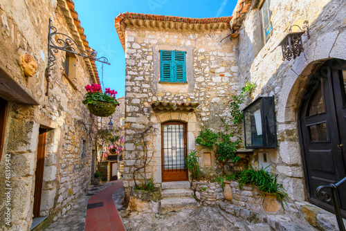 Fototapeta Naklejka Na Ścianę i Meble -  The narrow hillside alleys and streets of shops and cafes inside the medieval hilltop village of Eze, France, along the Cote d'Azur French Riviera.	
