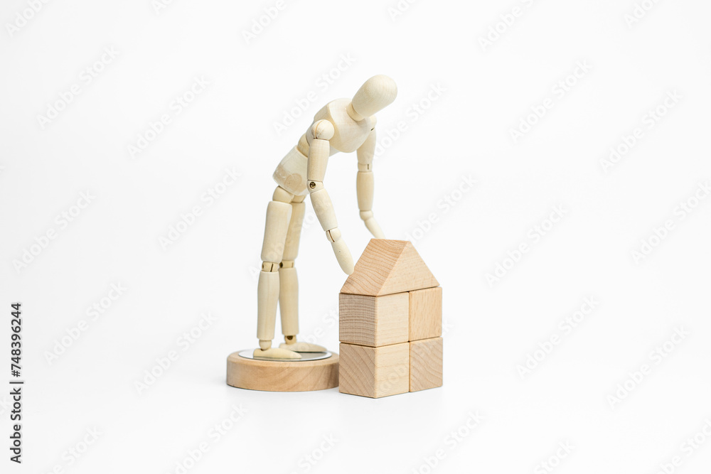 Wooden doll with wooden toy block isolated on white background. business or creative concept