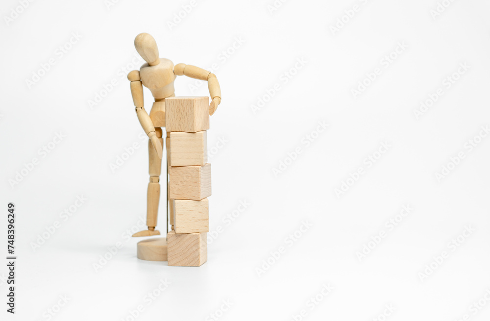 Wooden doll with wooden toy block isolated on white background. business or creative concept Wooden doll with wooden toy block isolated on white background. business or creative concept