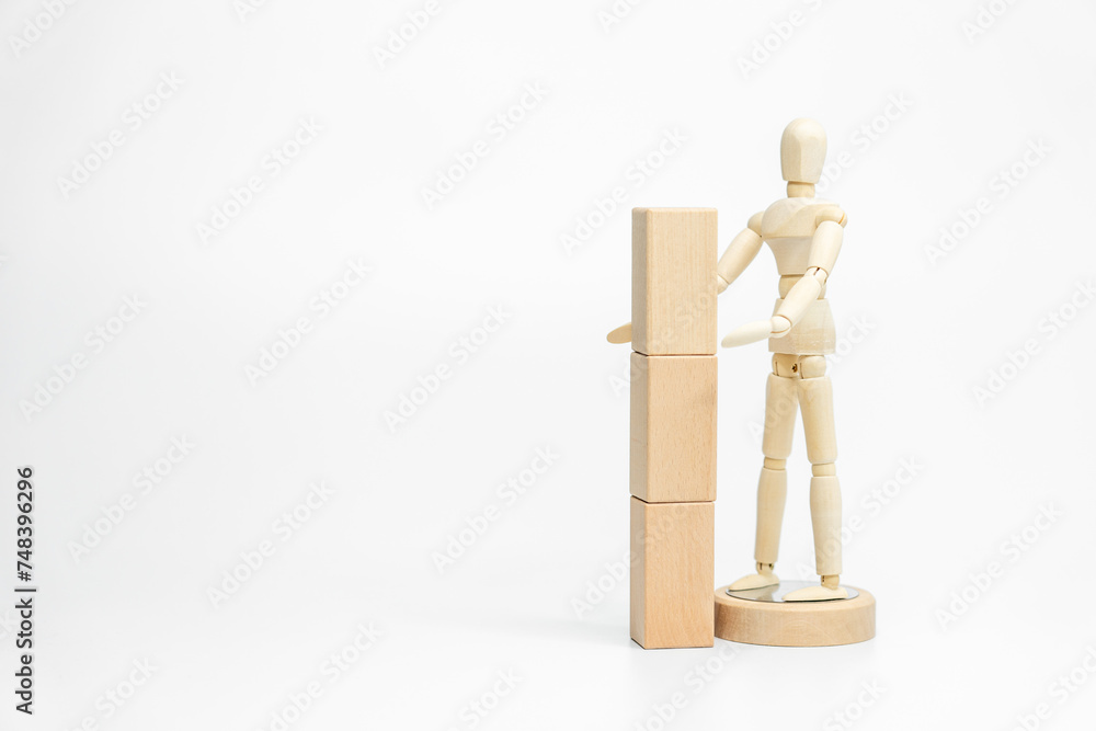 Wooden doll with wooden toy block isolated on white background. business or creative concept Wooden doll with wooden toy block isolated on white background. business or creative concept