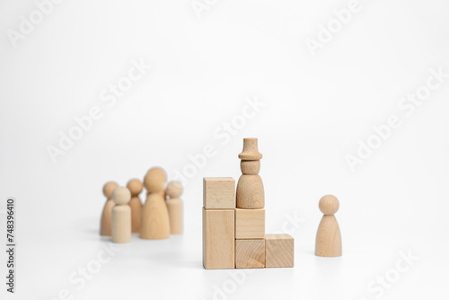 Wooden doll with wooden toy block isolated on white background. business or creative concept