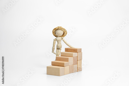 Wooden doll with wooden toy block isolated on white background. business or creative concept