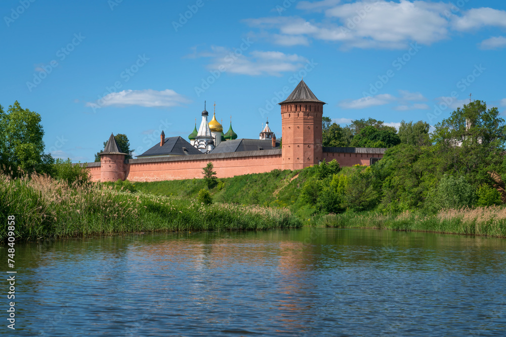 View of the Spaso-Evfimiev Monastery (a monastery of the Vladimir Diocese of the Russian Orthodox Church) on the bank of the Kamenka River on a sunny summer day, Suzdal, Vladimir region, Russia