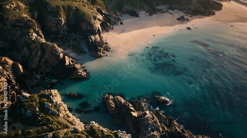 Aerial view of Porthcurno beach along the coastline with cliffs and The Minack Theatre at sunset Cornwall United Kingdom : Generative AI