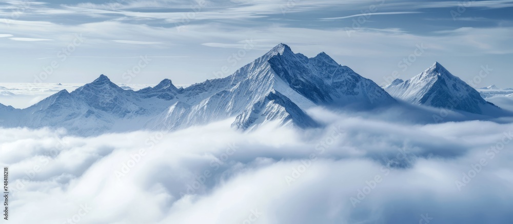Majestic mountain range covered in swirling clouds at high altitude