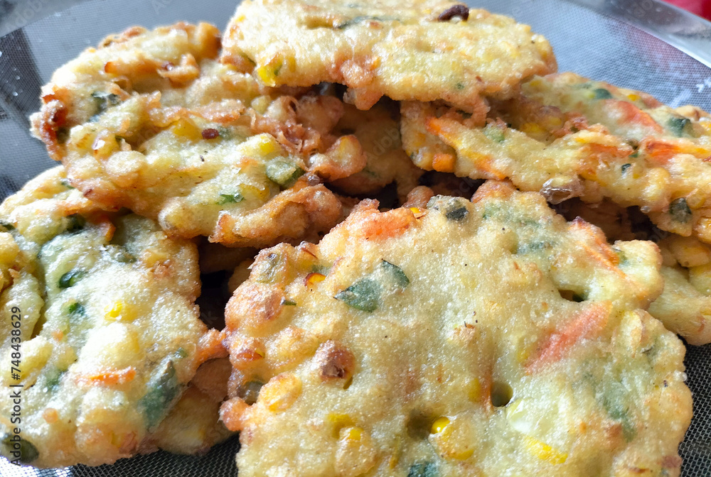 Perkedel Jagung or Bakwan Jagung, corn fritters is Indonesian traditional food. Savoury snack made of corn, egg, flour, spring onion, pepper and salt. Served in plate.
Perkedel Jagung or Bakwan Jagung, corn fritters is Indonesian traditional food. Savoury snack made of corn, egg, flour, spring onion, pepper and salt. Served in plate.