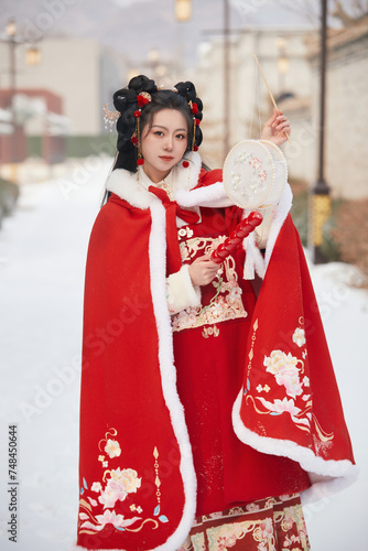 An Asian girl outdoors wearing ancient clothing during the Chinese Spring Festival
