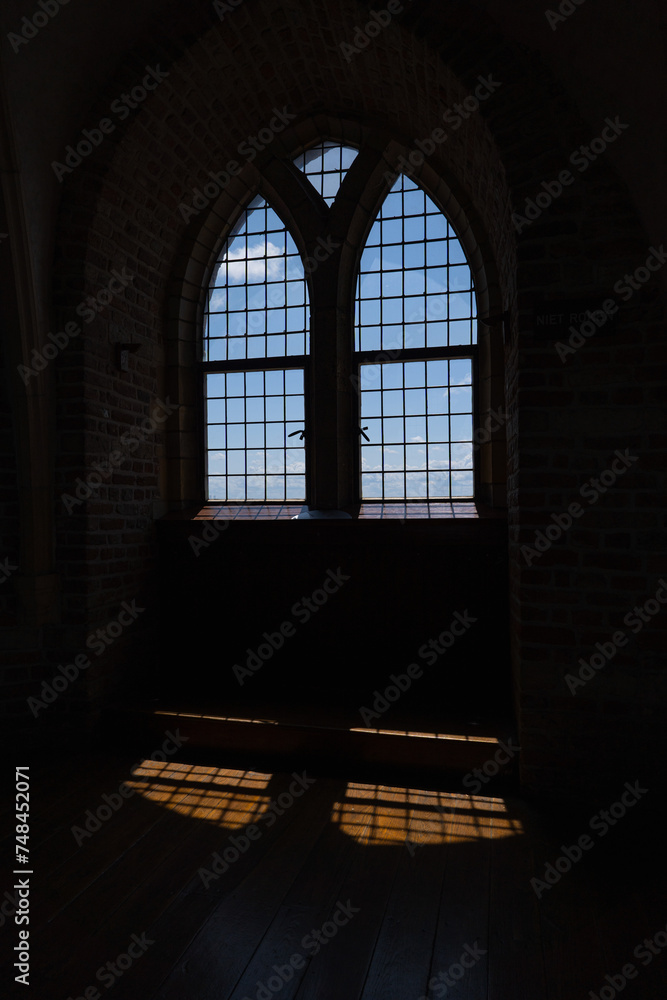 A church window casting its shade over the floor. A church window casting its shade over the floor.