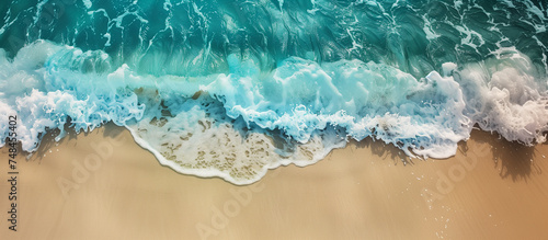 Soft blue ocean wave on fine sandy beach - nature, water, and relaxation