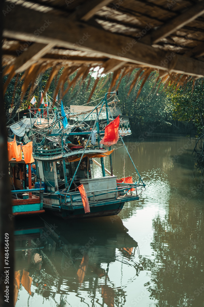 Obraz premium Fisherman's village and fishing boats at the canal by the sea.​Fisherman's village and fishing boats at the canal by the sea.​Fisherman's village and fishing boats at the canal by the sea.​