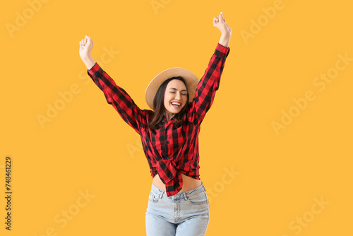 Young woman on yellow backg...