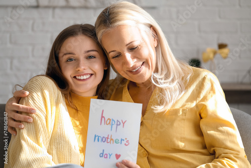 Young woman greeting her mo...