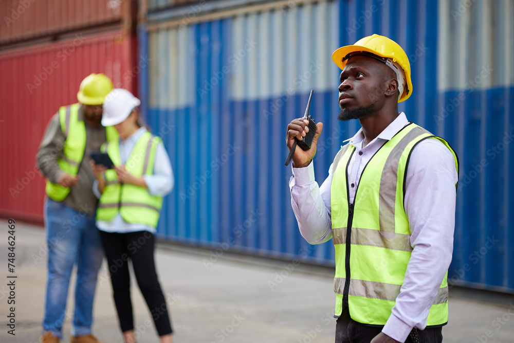worker or engineer using walkie talkie and talking about work in containers warehouse storage worker or engineer using walkie talkie and talking about work in containers warehouse storage