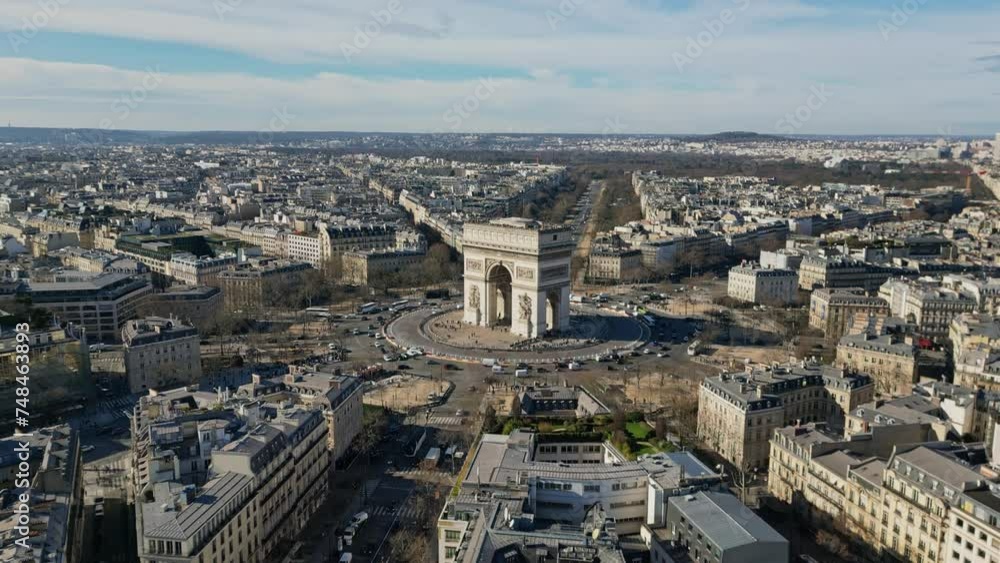 Triumphal arch or Arc de Triomphe and car traffic on roundabout with Paris cityscape, France. Aerial forward and sky for copy space Triumphal arch or Arc de Triomphe and car traffic on roundabout with Paris cityscape, France. Aerial forward and sky for copy space