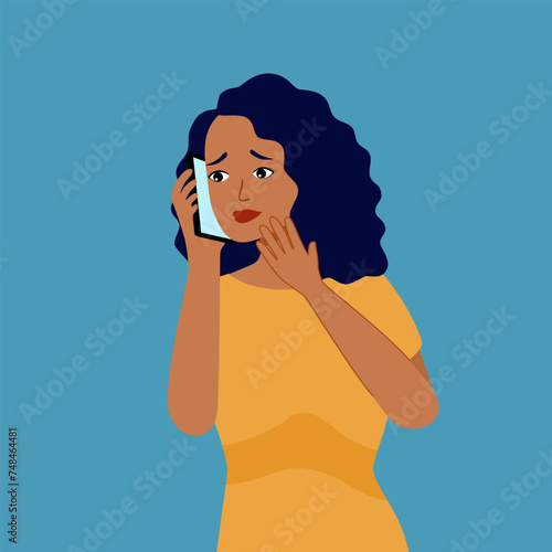 Shocked black woman talking on mobile phone with fear and anxiety. African American girl using smartphone with amazing expression.