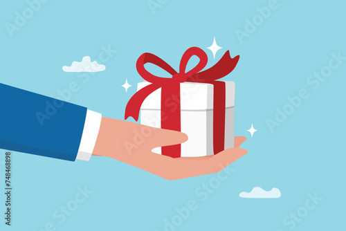 Gift reward program, bonus or surprise present for customer, employee reward or lucky prize, birthday gift box or festive incentive, special loyalty program concept, hand giving gift box with ribbon. © Nuthawut