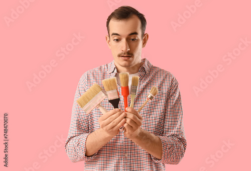 Young man with paint brushe...