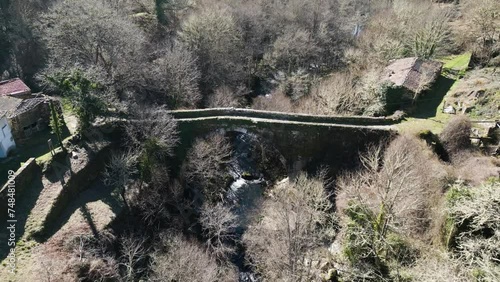 Aerial pullback along river above Navea Bridge Ourense Spain photo