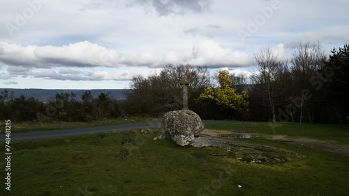 Chapel of San Vitoiro pan across carved stone cross and grassy lawn photo