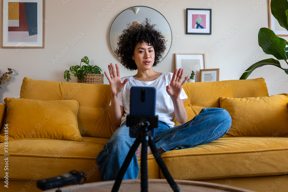 Φωτογραφία Young african american mixed race woman recording video talking to followers during live stream on social media