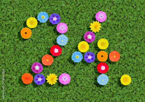 number written with colorful flowers on green clover background photo