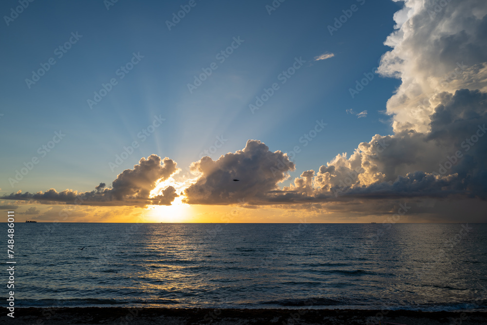 Dramatic sunset and cloudy sky. sea. Calm sea with cloudy sky through the clouds over. Sunset ocean and cloudy sky background. Tranquil seascape. Horizon over the sunset sea water. Calm cloudy sky.