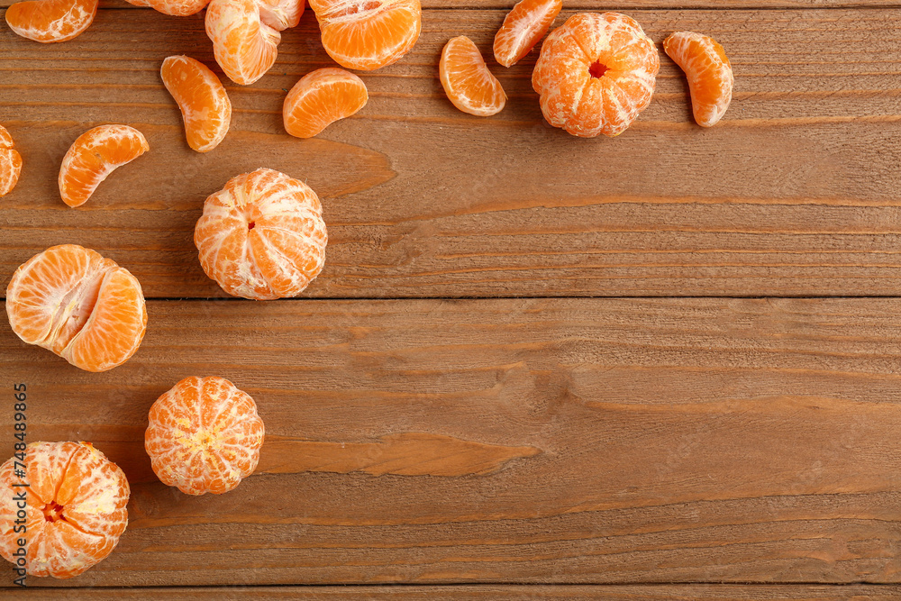 Peeled sweet tangerines on wooden background Peeled sweet tangerines on wooden background