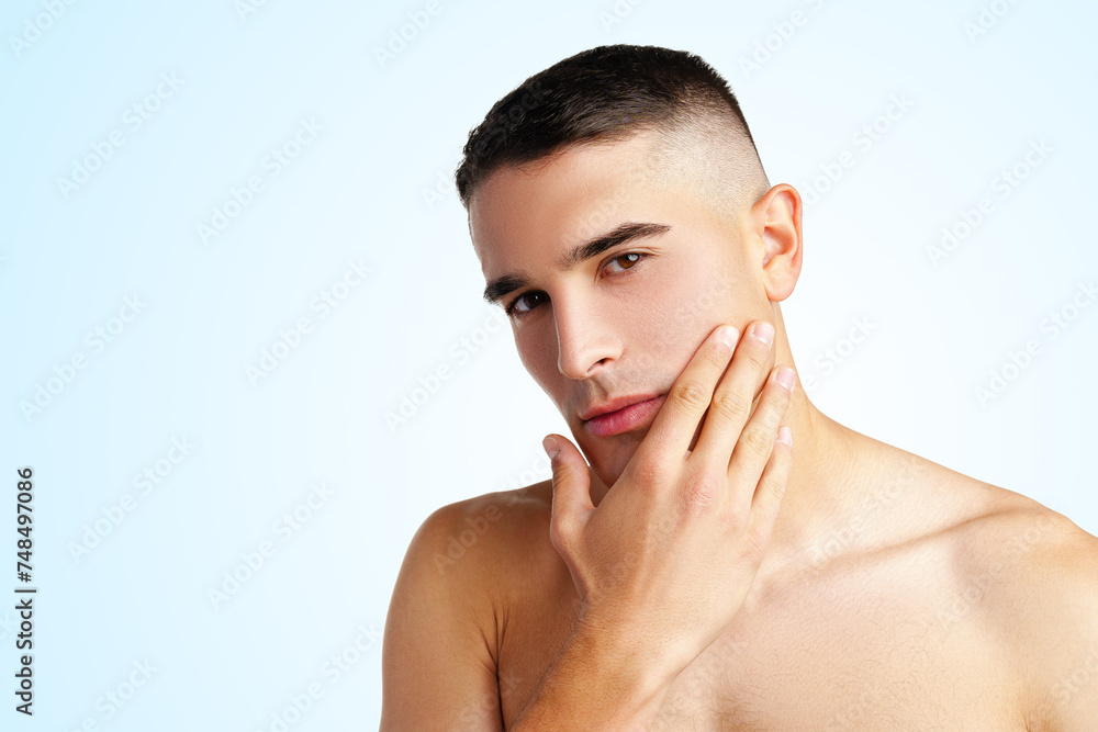 Young attractive brunet guy with perfect skin touching chin on white background Young attractive brunet guy with perfect skin touching chin on white background