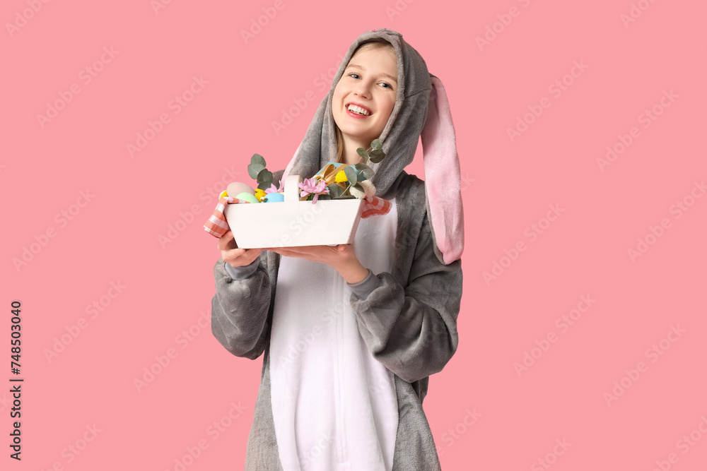 Beautiful young happy woman in bunny costume with basket full of eggs on pink background. Easter celebration Beautiful young happy woman in bunny costume with basket full of eggs on pink background. Easter celebration