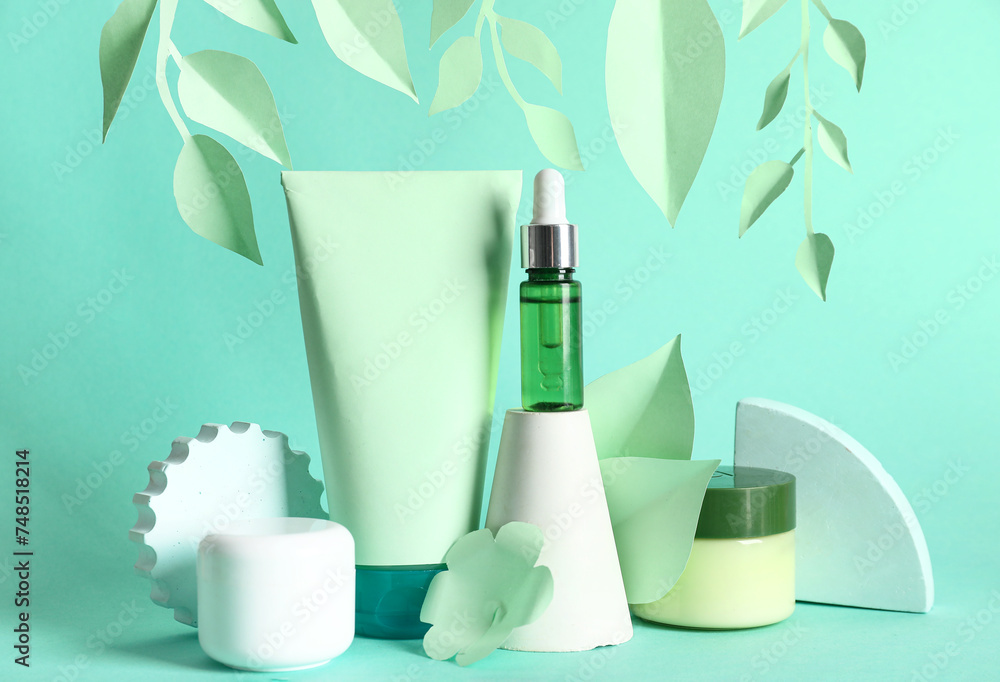 Facial cosmetic products composition with paper flowers on green background Facial cosmetic products composition with paper flowers on green background
