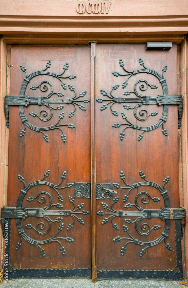 Antique old wooden door with iron fittings.
Antique old wooden door with iron fittings.