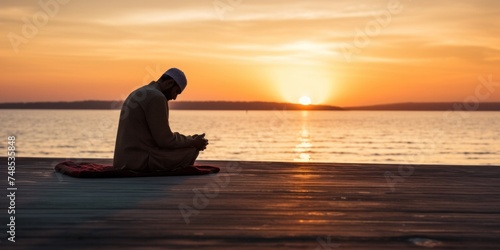Muslim man praying at sunset on the beach