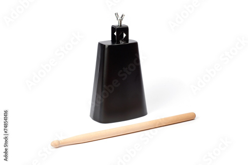 Fotografija Cowbell percussion musical instrument, black metal with a wooden stick
